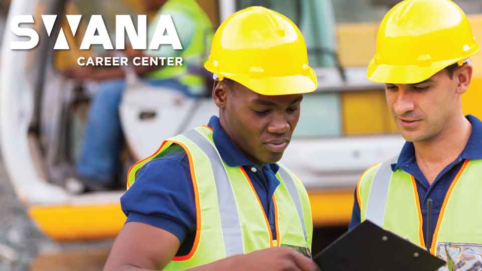 Two men in hard hats checking a clipboard